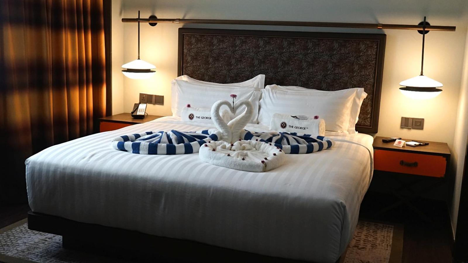 The George Penang By The Crest Collection Hotel George Town Exterior photo A bed with a towel swan